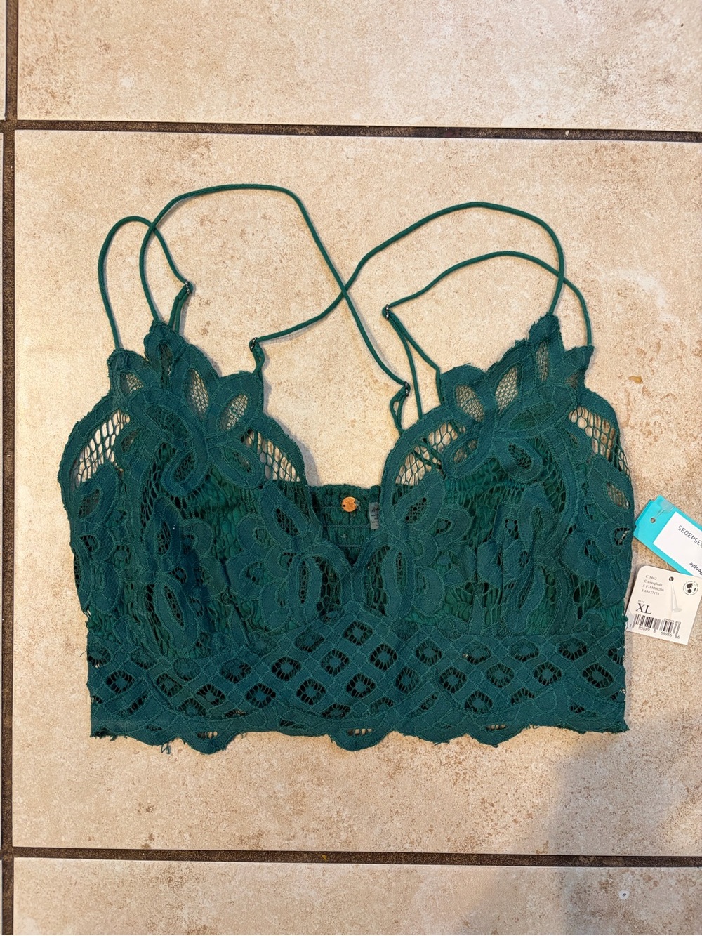 Free People Adella bralette in hunter green with floral lace and crossed straps.